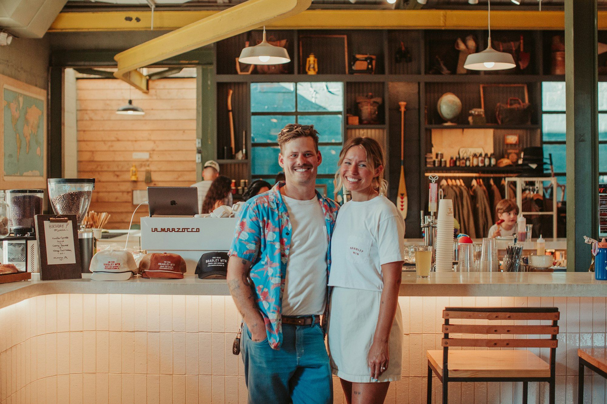 Two business owners standing together at the counter of their restaurant